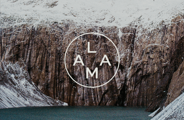 Barman of Demazzi Stone Grill holding two cocktails.