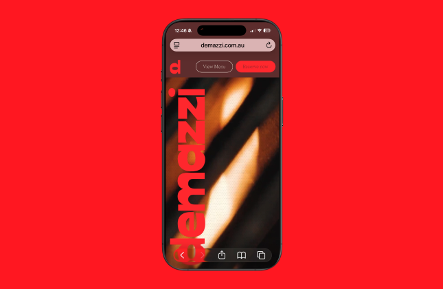 Demazzi Stone Grill Website shown displaying on a mobile phone.